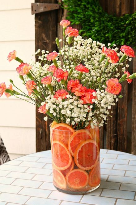 Floral arrangement using sliced oranges as packing and medium