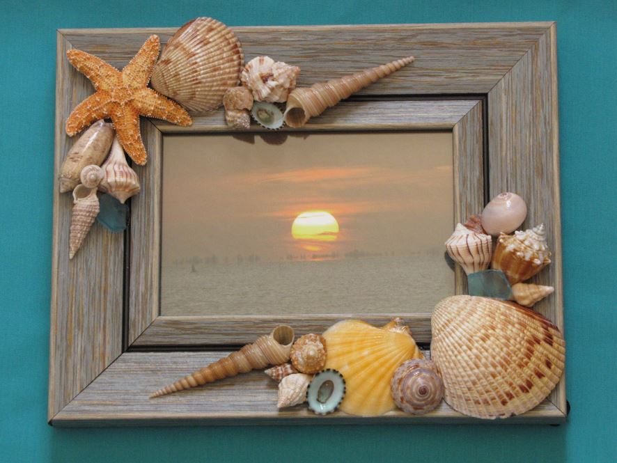 Natural wood picture frame decorated with sea shells 